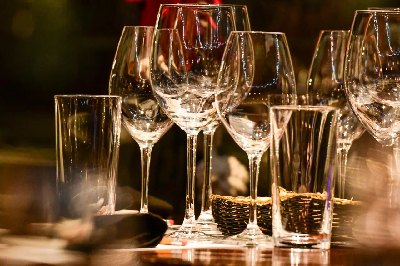 Close-up of wine glasses on a table in warm evening light